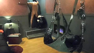 Mistress Acanthus raises her slave on a leash to the whip on the cross