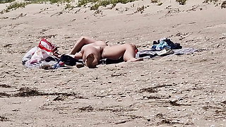 close-up of the pussy and tits of a woman sunbathing alone