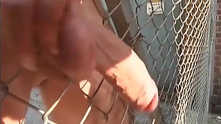 Gimp gets his big dick rubbed outdoor by the mistress