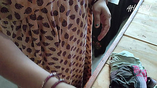 Indian Girl Folding Clothes in Her Bedroom