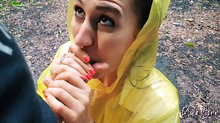 Slutty Brunette in a yellow raincoat sucks me outdoors in the rain