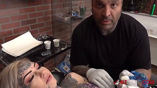 Sascha plays with Amber Luke while she gets tattooed