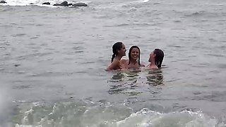 Three girls finger each other deeply on the beach